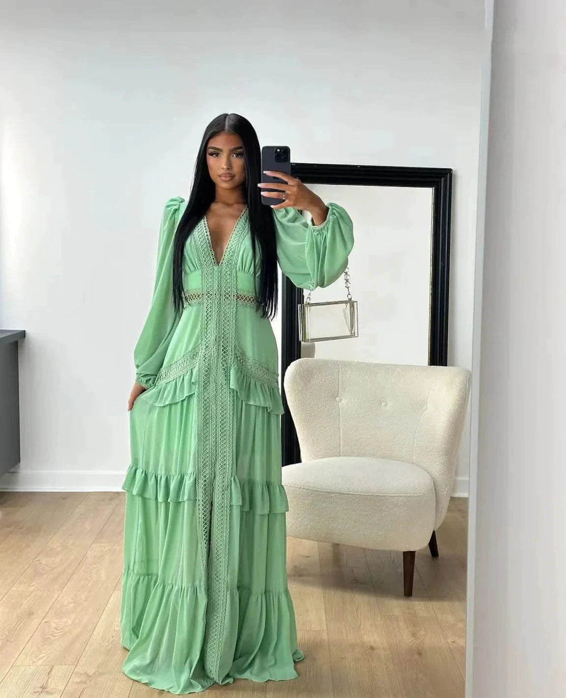 Long, openwork dress with a V-neck, empire waist, and lantern sleeves