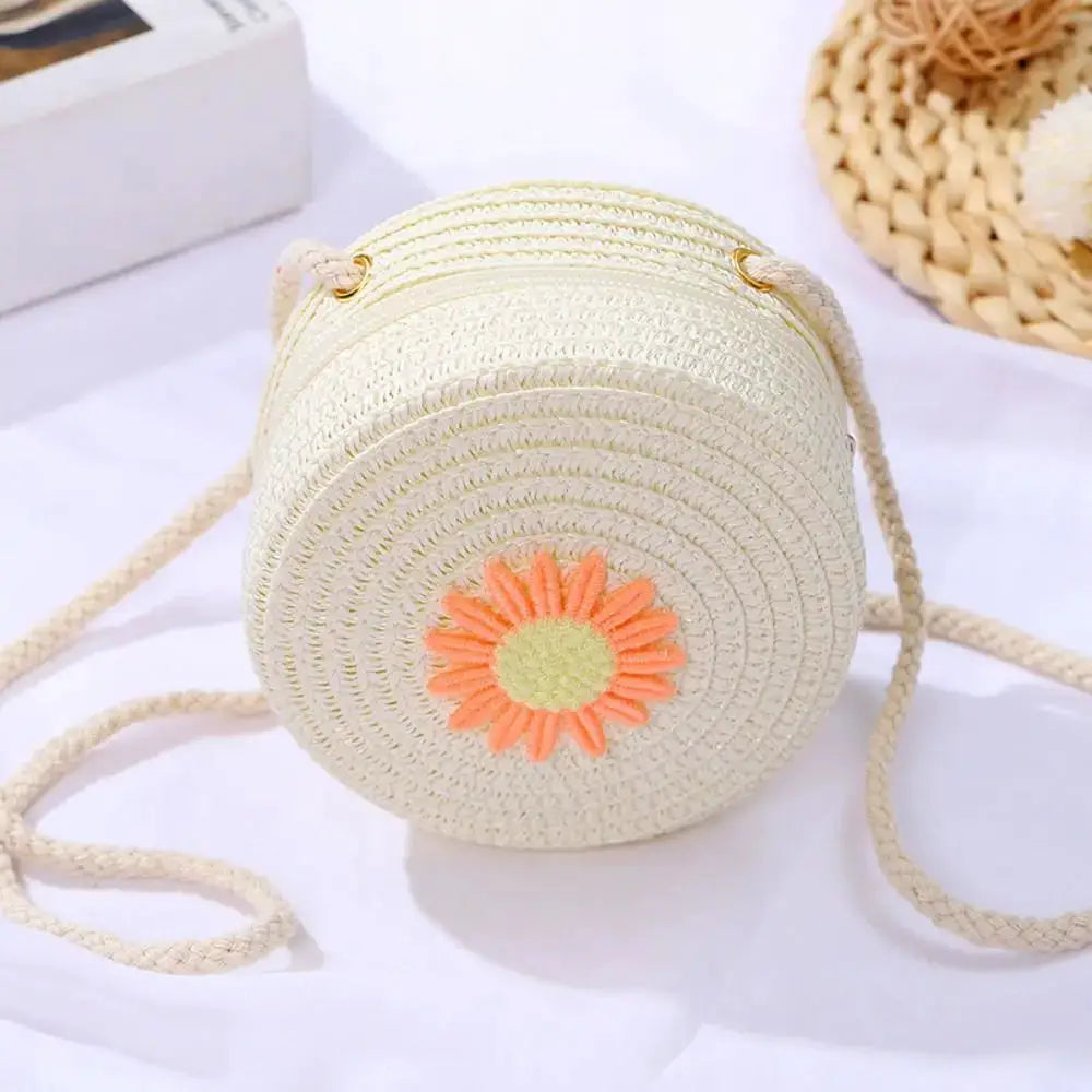 Sac rond en rotin tissé, bandoulière, crème avec fleur orange centrale, fait à la main.